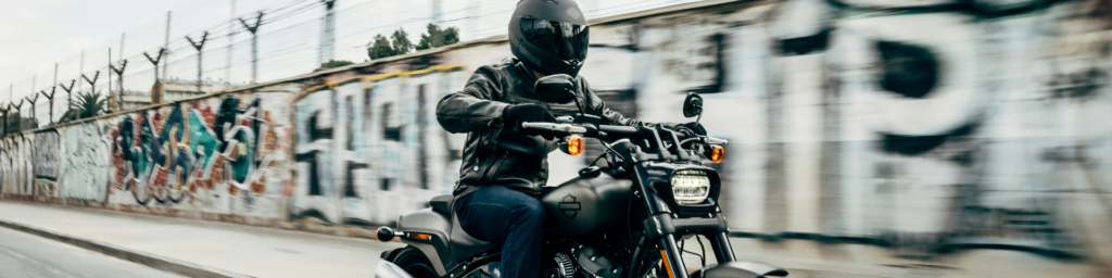 person riding motorcycle on concrete road